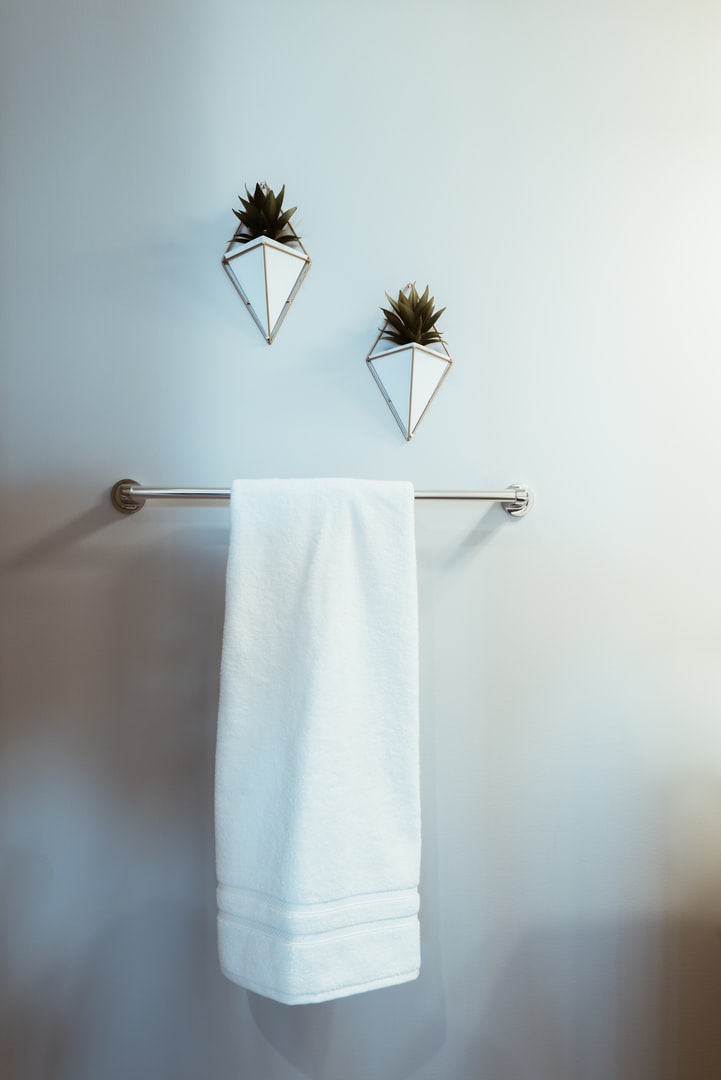 White hotel towel on towel rack