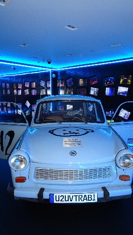 Light-blue vintage trabant in U2 museum with space baby logo on bonnet