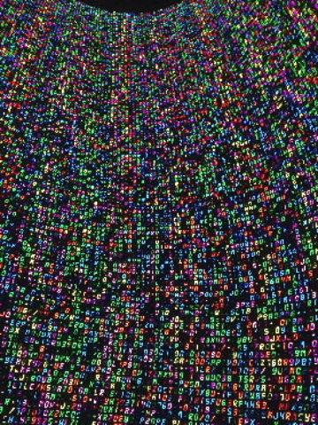 Floor to ceiling digital imagery of thousands of multi-coloured code-sequencing numbers