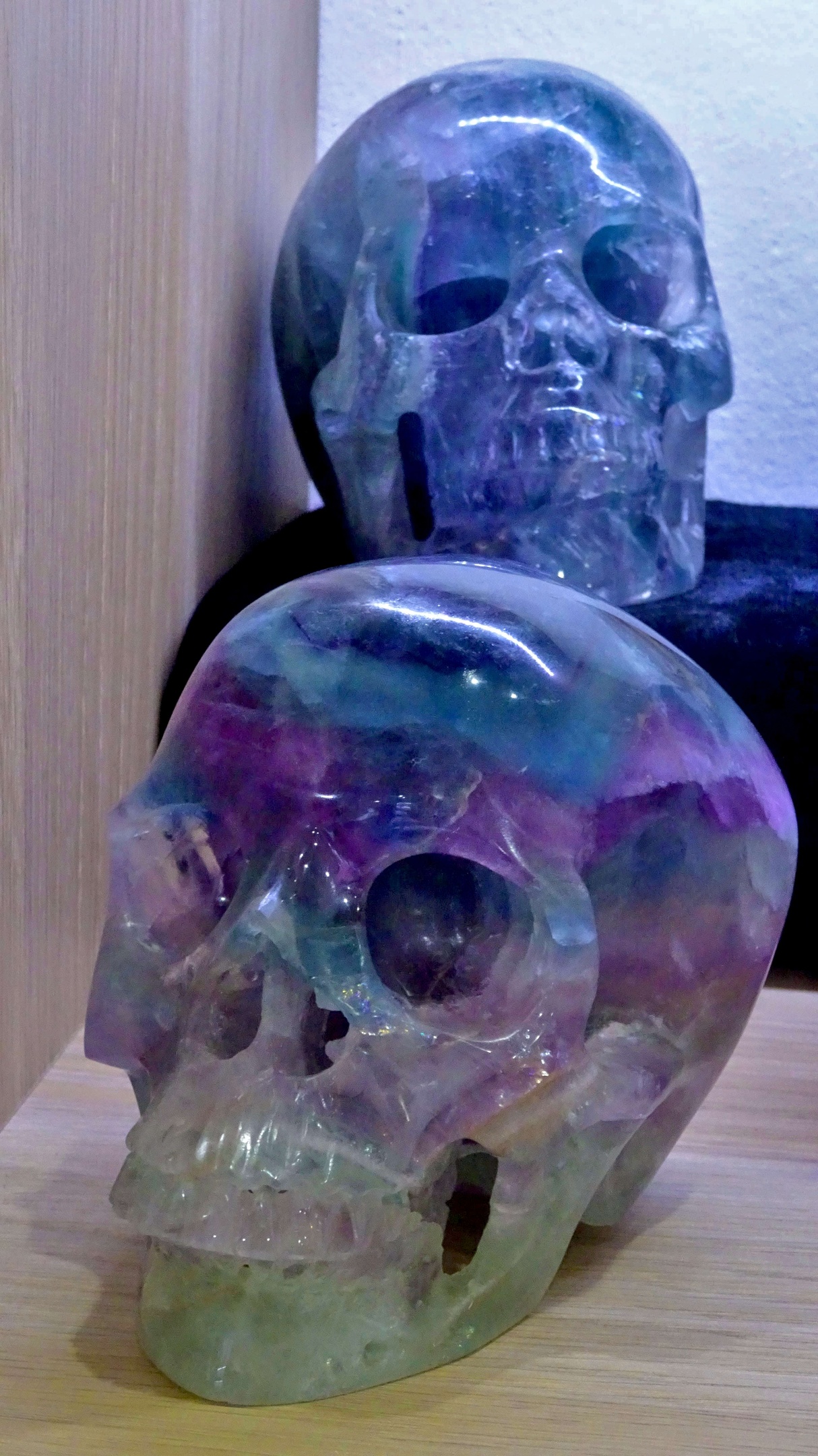 Two rainbow fluorite crystal skulls