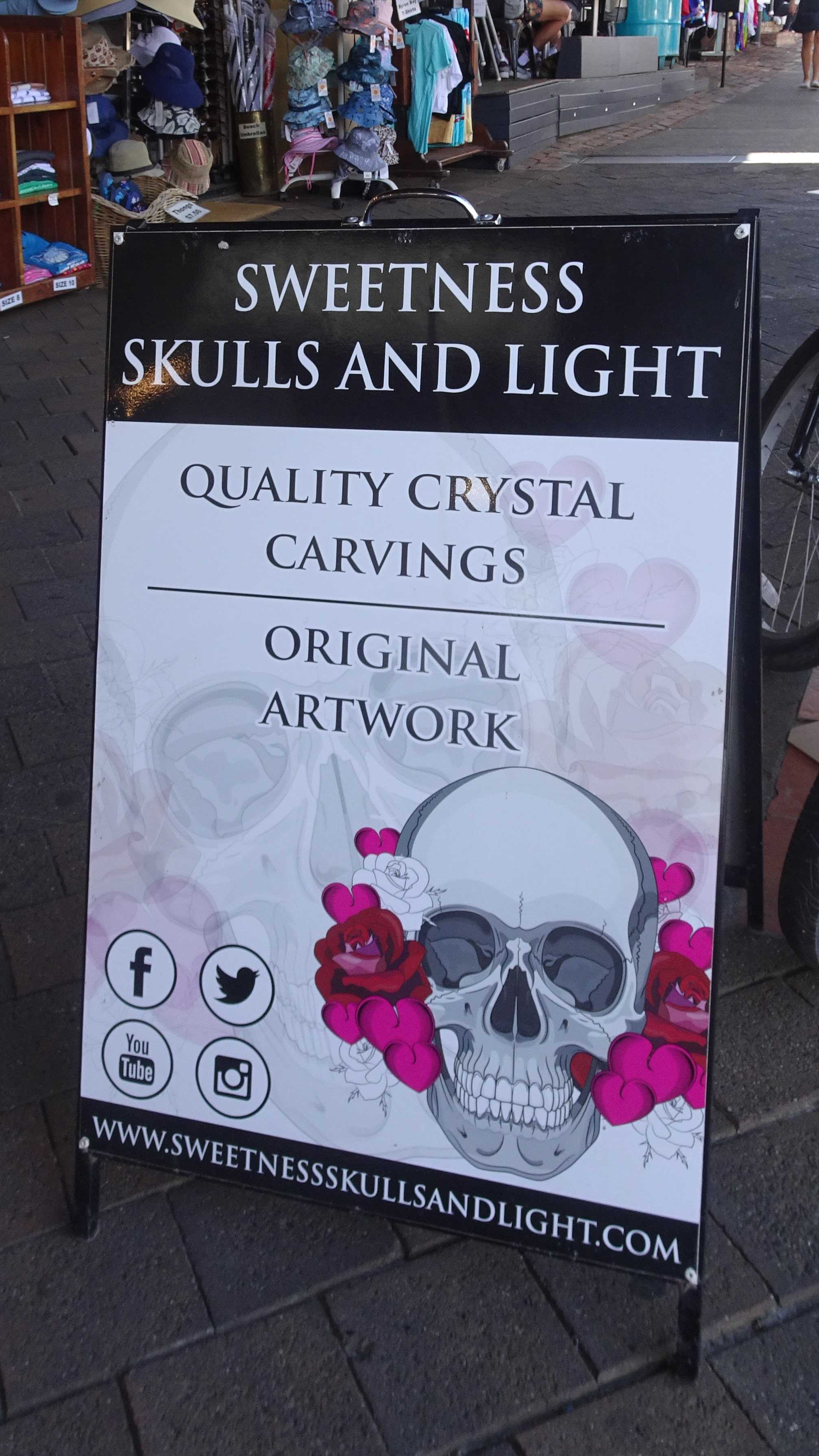 Signage on footpath for Crystal Skull Shop