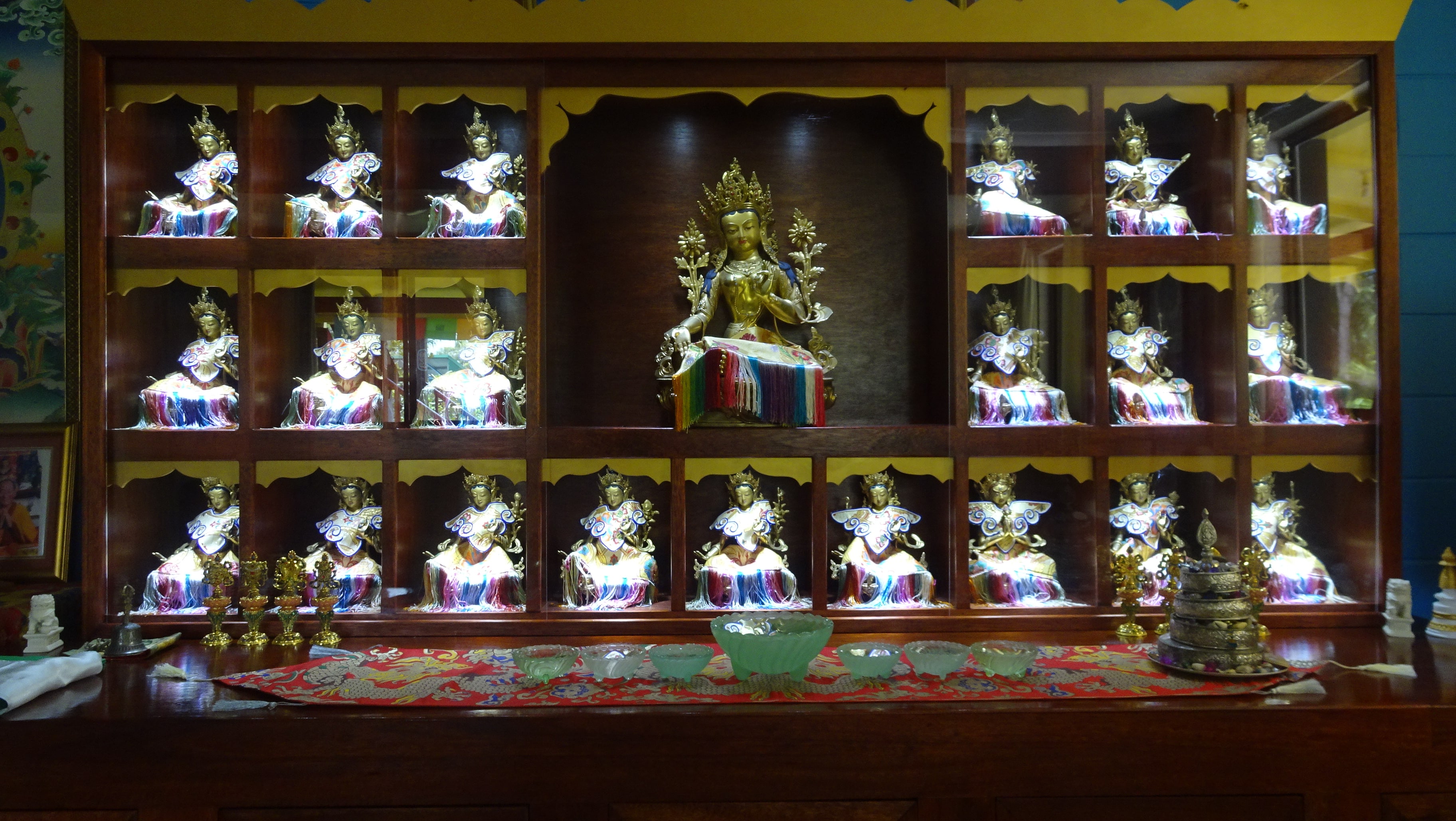 Wooden display case lined with Tara statues