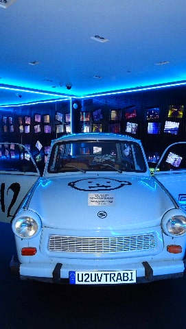 Light-blue vintage trabant in U2 museum with space baby logo on bonnet
