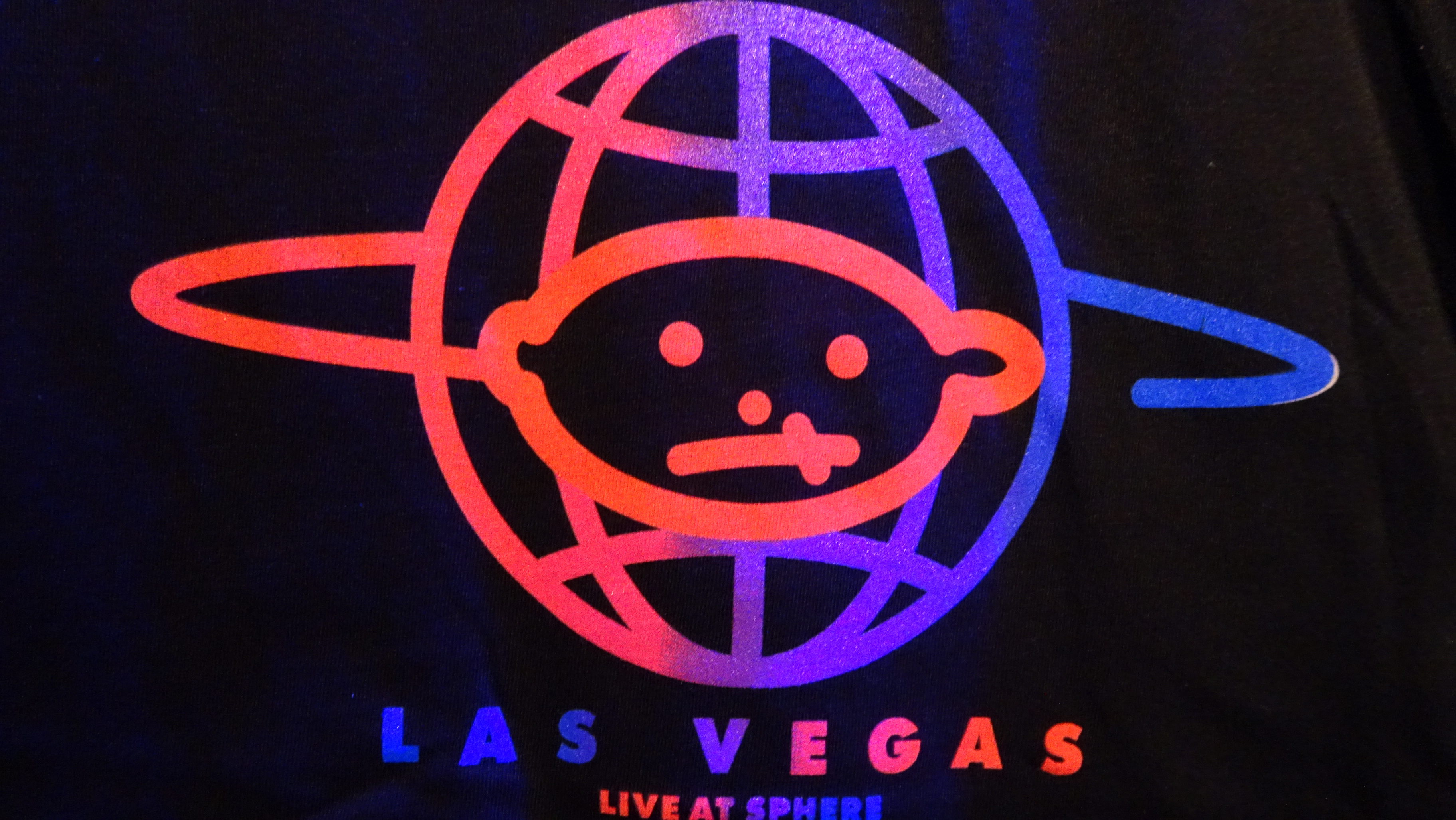 Brightly coloured space baby logo printed on black shirt