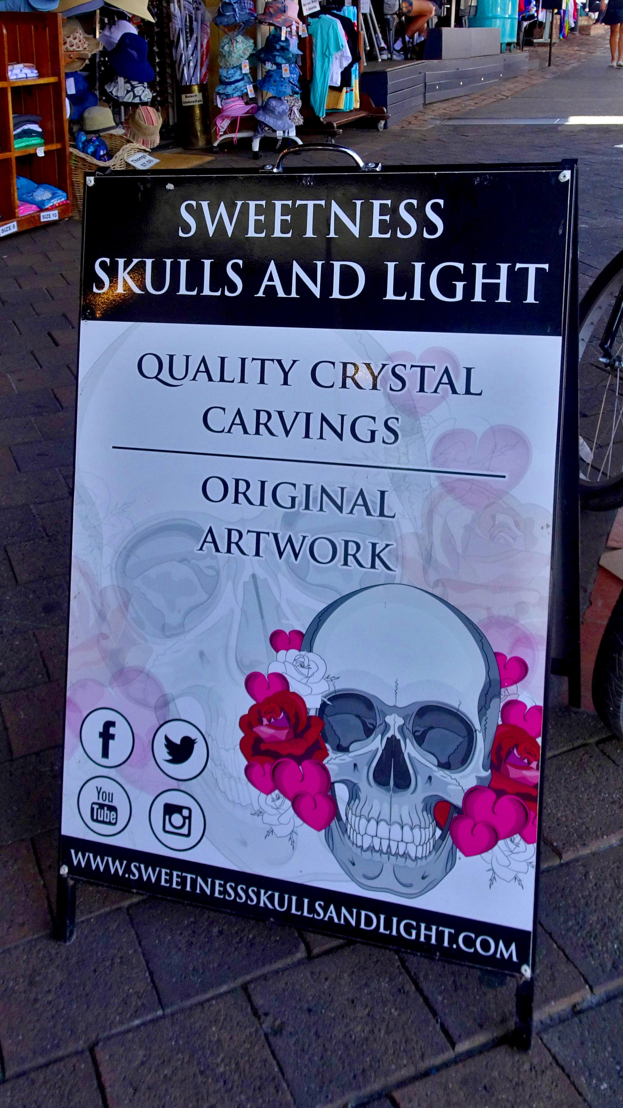 Signage on footpath for Crystal Skull Shop